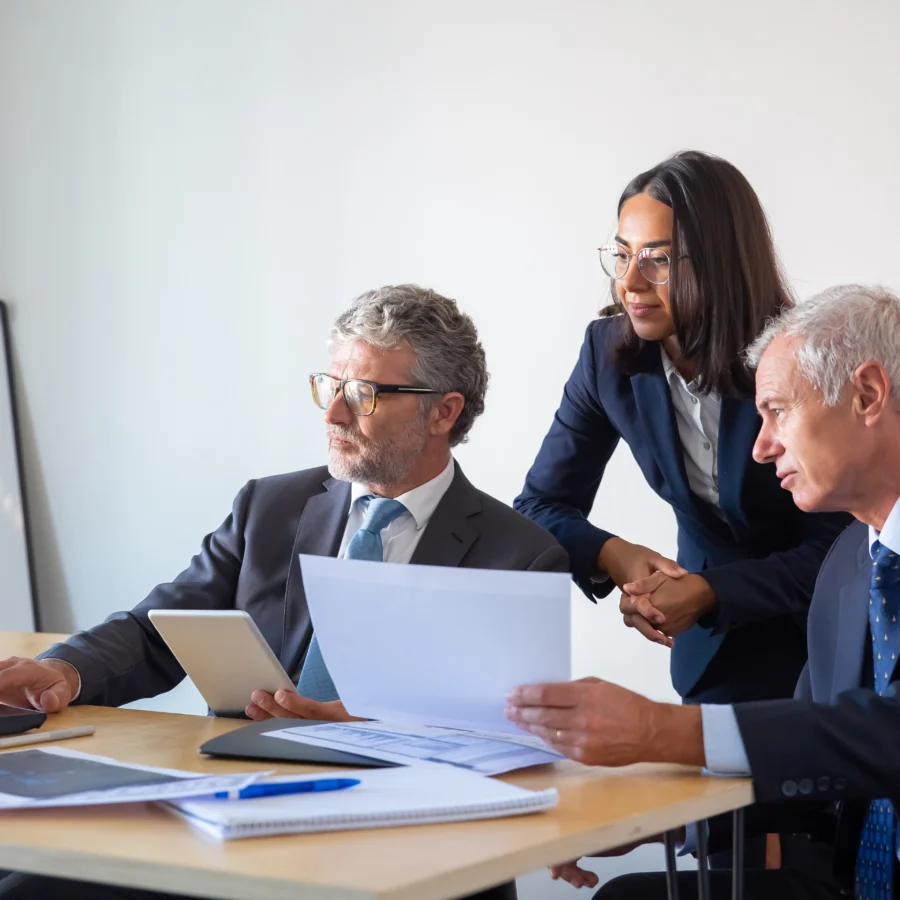 Serious looking, official, concentrated colleagues using laptop and working with documents. CPS stands for Corporate Project Solutions, we are not the crown prosecution service 2